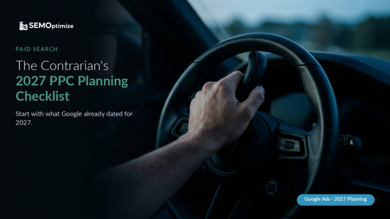 A driver's hand grips the steering wheel of a car at dusk, the road ahead soft and out of focus